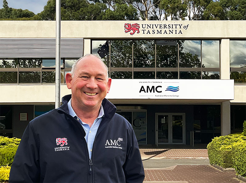 Mal Wise standing in front of entrance to AMC building